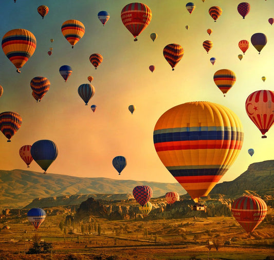 Cappadocia hot air balloons over fairy chimneys and Göreme Open Air Museum with Byzantine cave churches