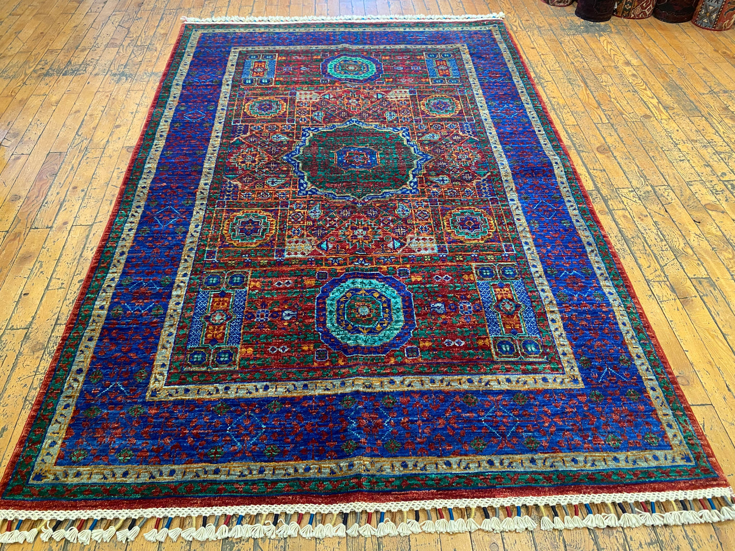 Decorative rug with intricate patterns on a wooden floor