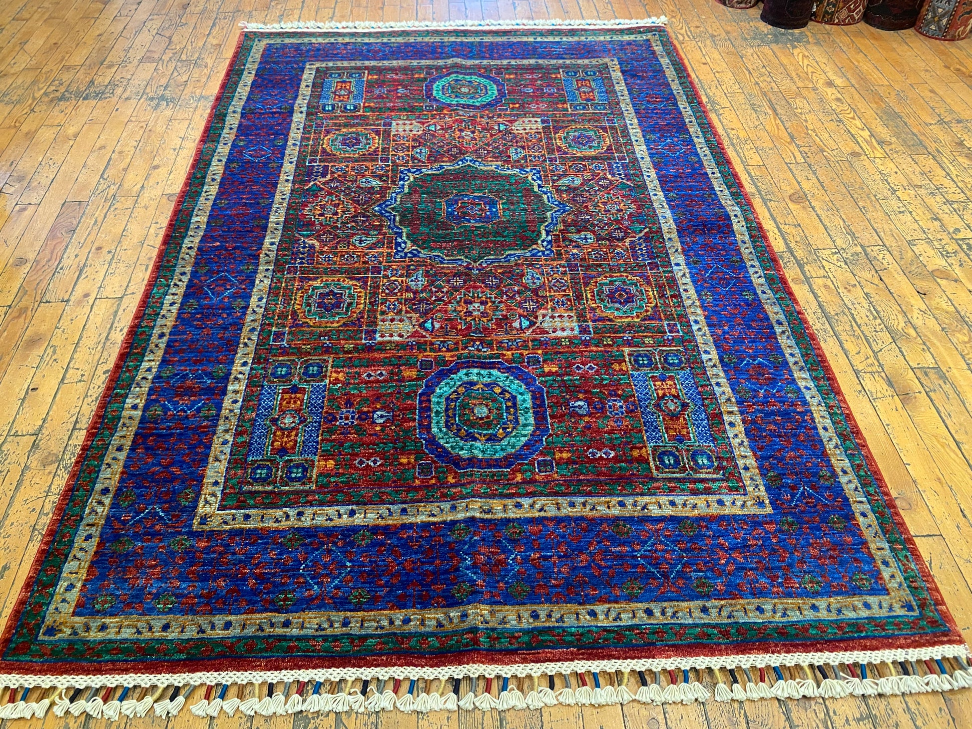 Decorative rug with intricate patterns on a wooden floor