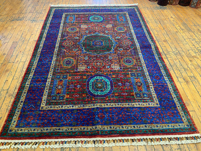 Decorative rug with intricate patterns on a wooden floor