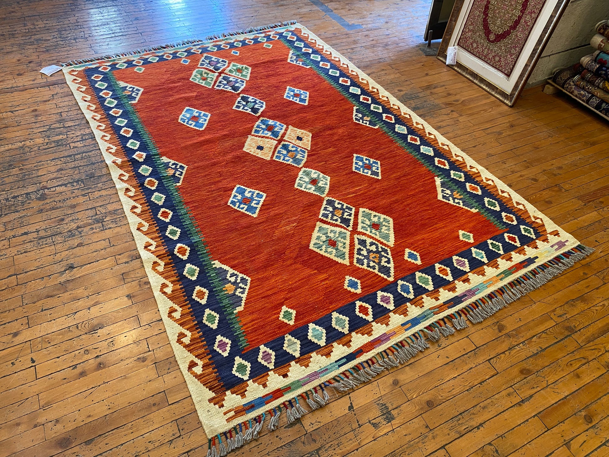Decorative rug with geometric pattern on a wooden floor