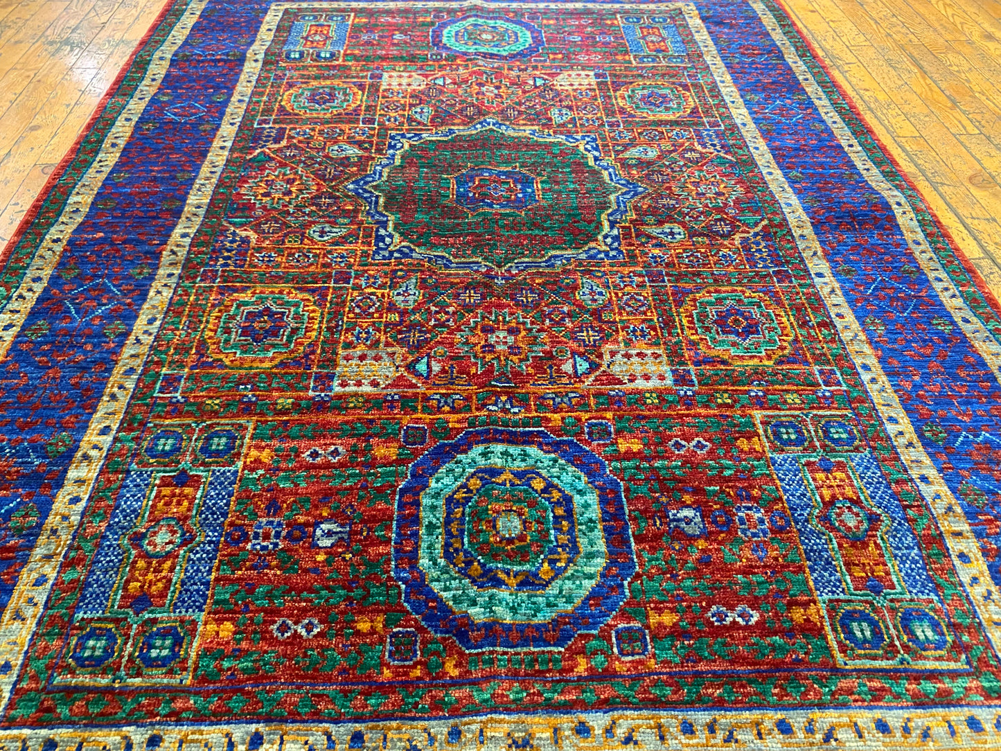 Colorful patterned rug on a wooden floor