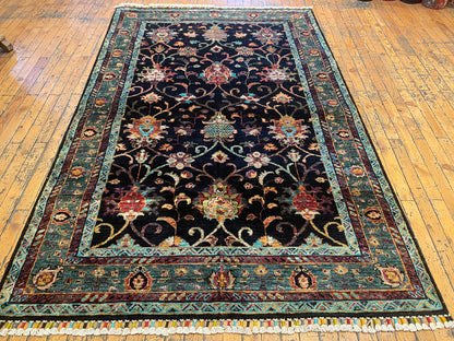Decorative rug with intricate patterns on a wooden floor