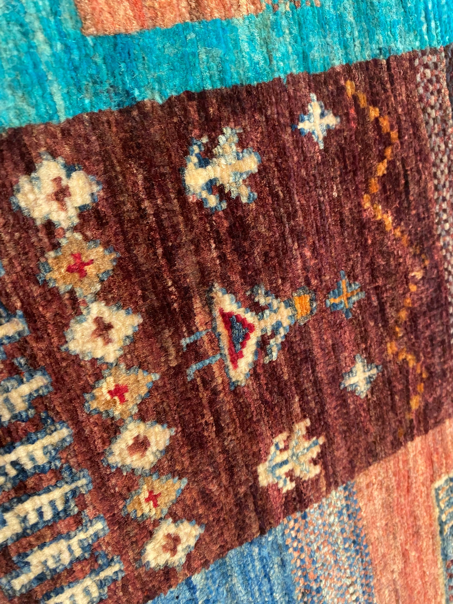 Close-up of a patterned rug with decorative elements on a multicolored background