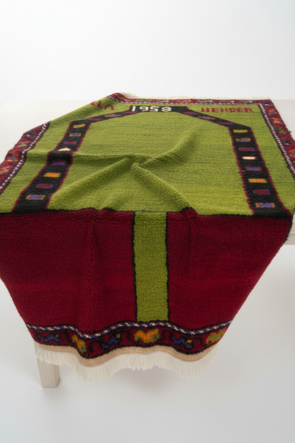 Green Anatolian Rug Draped on Table
