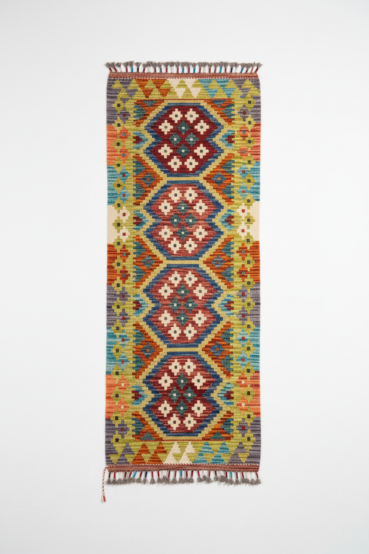 Kilim rug hanging on white wall